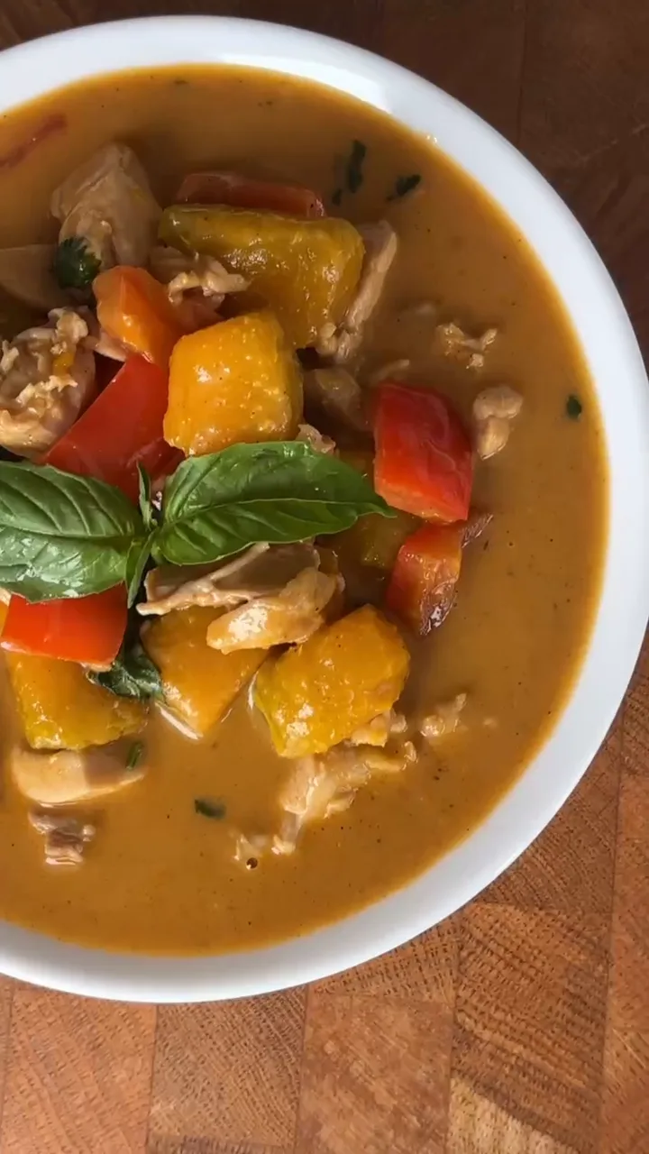 A colorful pepper and chicken curry finished with basil
